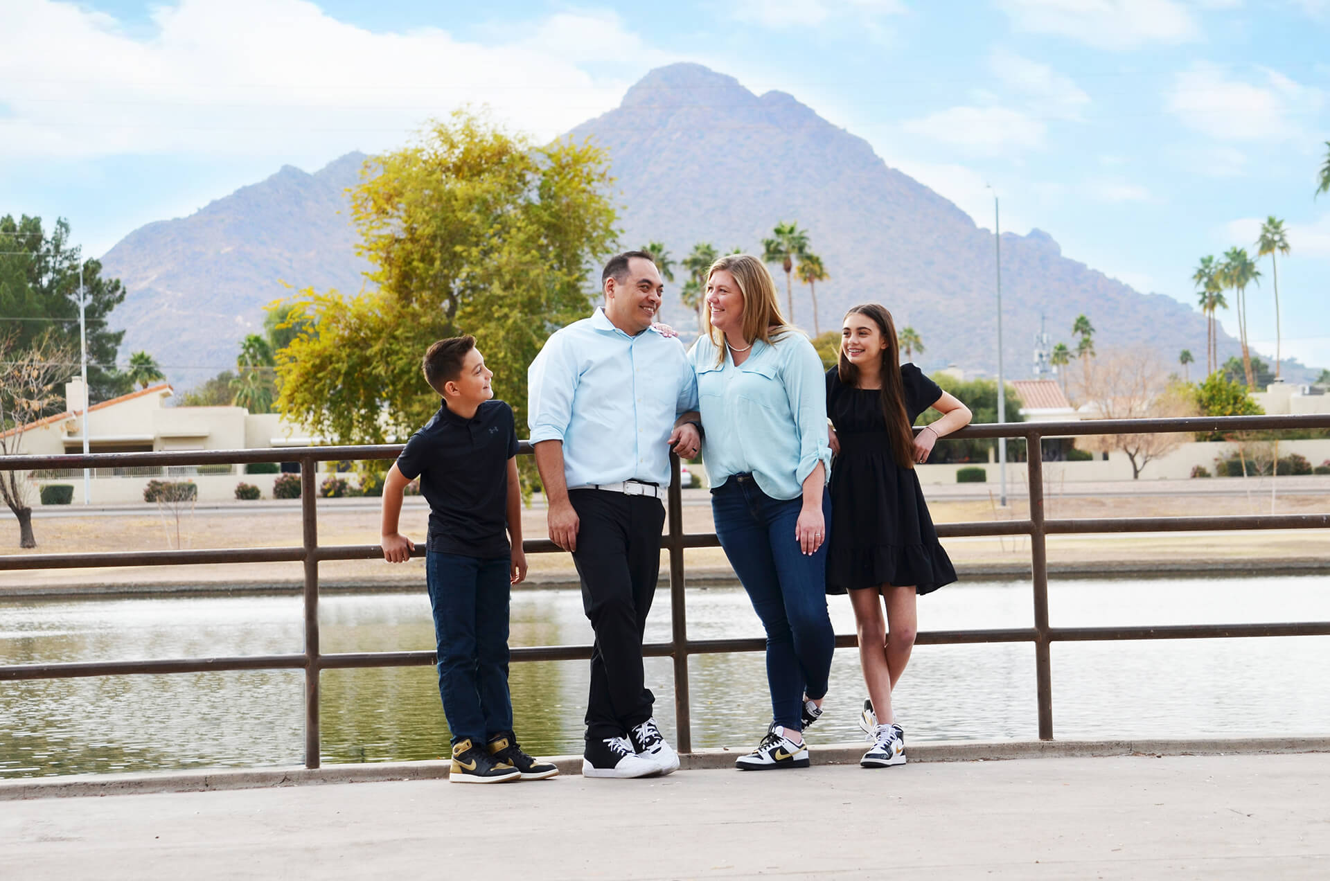 Brain and his wife and two kids standing in front of a mountain